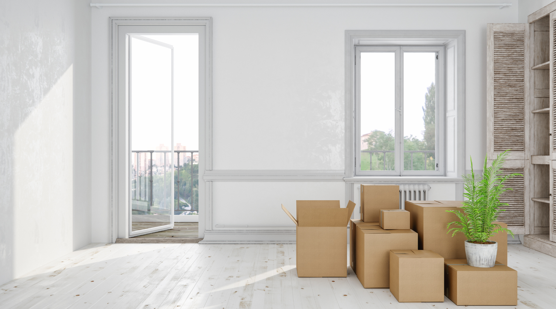 Bright, sunlit minimalist apartment with cardboard moving boxes 