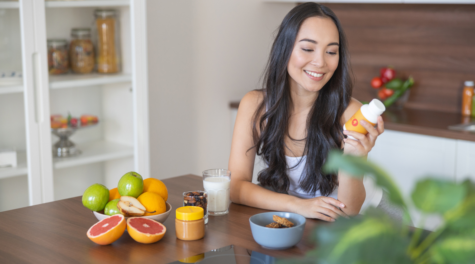 Woman holding natural vitamins for gut health and digestive support.